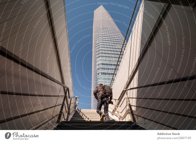 Man climbing the stairs to the skyscraper - 8 Stairs Office City High-rise Human being Exterior Modern Business center up Madrid Success Town Skyline Spain
