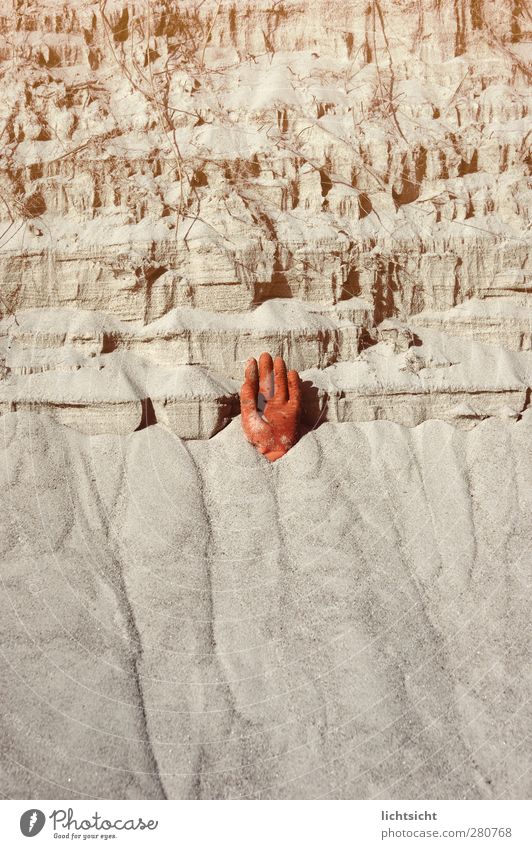 Hand in the sand Fingers Environment Elements Coast Beach Sand Orange Spill Dismantling Hold Stop Dangerous Risk Stick out Gloves Steep face Cliff