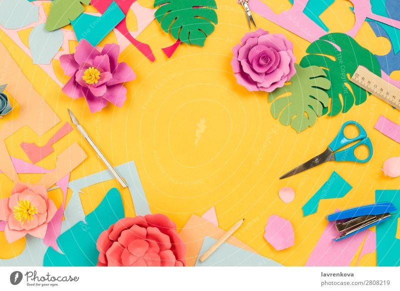 Stationary supplies and papercraft flowers on yellow background - a Royalty  Free Stock Photo from Photocase