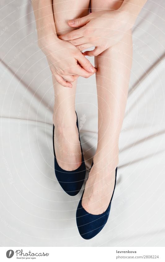 Above shot of white woman holding her legs in shoes Body Faceless Ankle High heels Hand Fashion Footwear Feet Human being Adults Legs Skin Young woman White