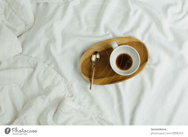 Cup of coffee and spoon on wooden tray in bed on white sheets Spoon Wood Tray Bedroom Espresso Healthy Healthy Eating holiday Tea Beverage Black Hot Morning
