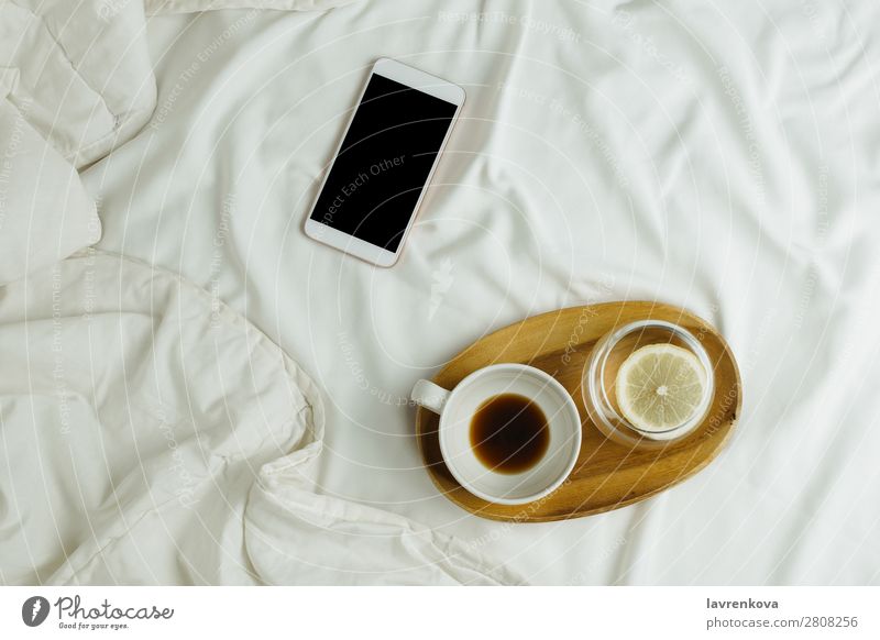 Cup of coffee and lemon water on wooden tray and smartphone Background picture Bedroom Beverage Black Breakfast Business cell Coffee Connection Espresso