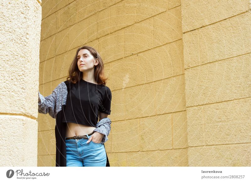 Portrait of young adult female in front of yellow wall Adults Attractive Beautiful Casual clothes Caucasian City Face Fashion Woman Young woman Hair Happy