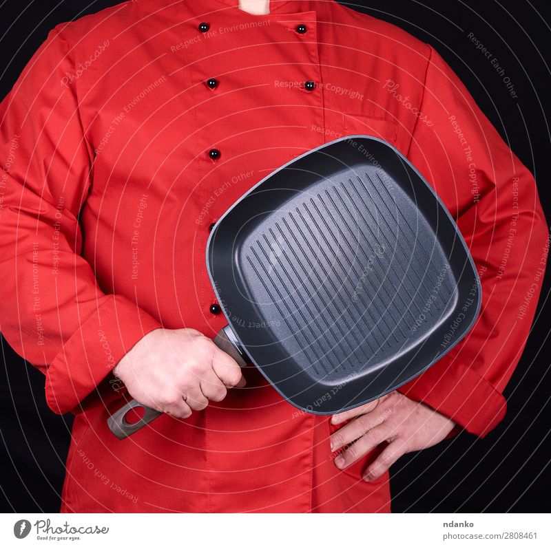 cook holding an empty square black frying pan Pan Kitchen Restaurant Cook Human being Man Adults Hand Clothing Red Black Cast iron Caucasian chef cooking