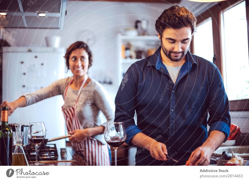 Young couple cooking. Man and woman in their kitchen Cooking Kitchen Home Dinner Youth (Young adults) Eating Wife Adults Smiling Interior design Husband Salad