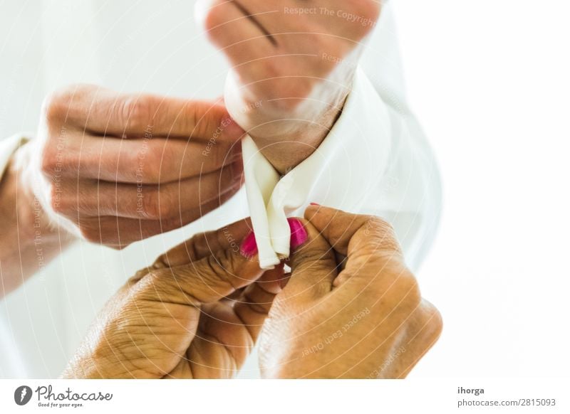 A groom putting on cuff-links in his wedding day. Elegant Style Wedding Office Business Masculine Feminine Woman Adults Man Hand 2 Human being Fashion Clothing