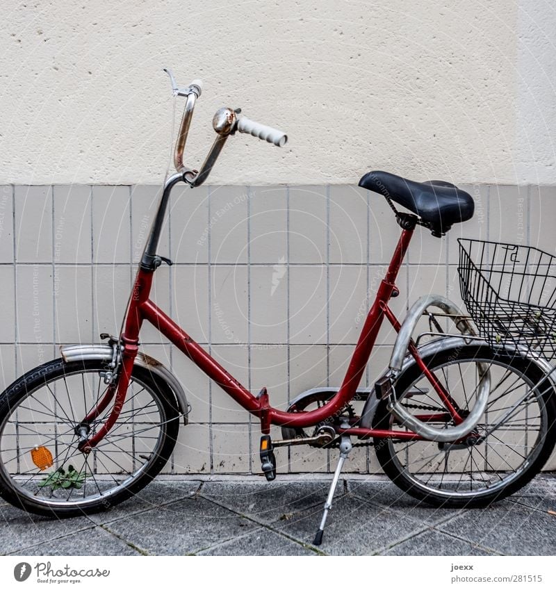city runabout Wall (barrier) Wall (building) Bicycle Old Hideous Retro Crazy Red Black White Past Folding bicycle chain lock Shopping basket Lock Colour photo