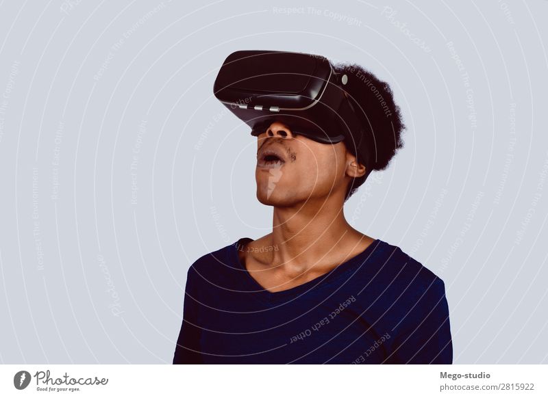 Afro American man experiencing virtual reality. Design Joy Playing Entertainment Business Headset Technology Human being Man Adults Shirt Beard Modern New