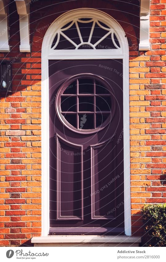 View of one vibrant purple door with round windows on London str Vintage Door Bright Black Yellow styled Front door Round Window Glass Wood Colour Multicoloured