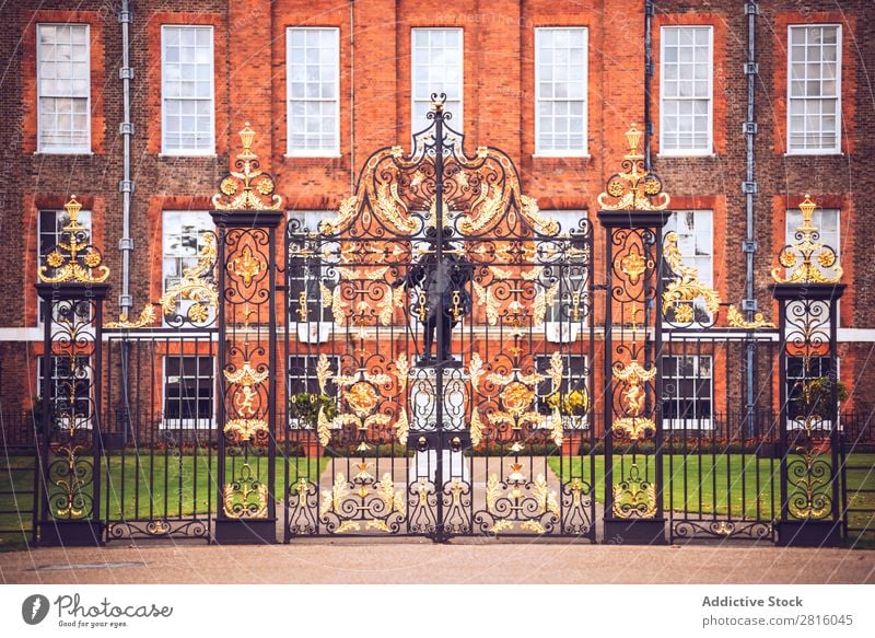 London, UK - October 13, 2016:Antique golden gates to Kensington Gate Gold Palace Royal England Historic Decoration Iron Art Monument Guard Entrance