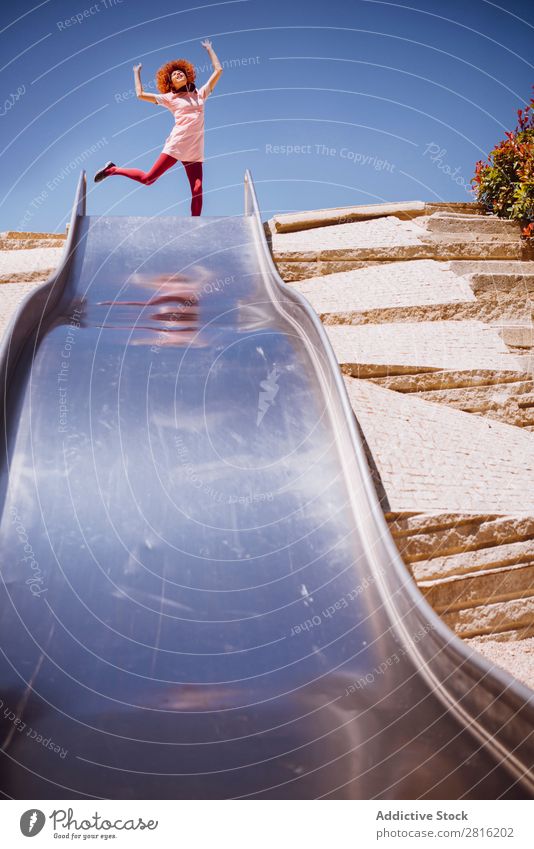 Young trendy woman playing in a park on slide Action Adults amusement Beautiful Beauty Photography Caucasian Cheerful Infancy Cute enjoyment Family & Relations