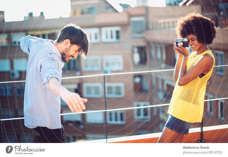 Interracial young couple taking pictures to each other and having fun Youth (Young adults) handsome Multicultural interracial Summer Exterior shot Easygoing