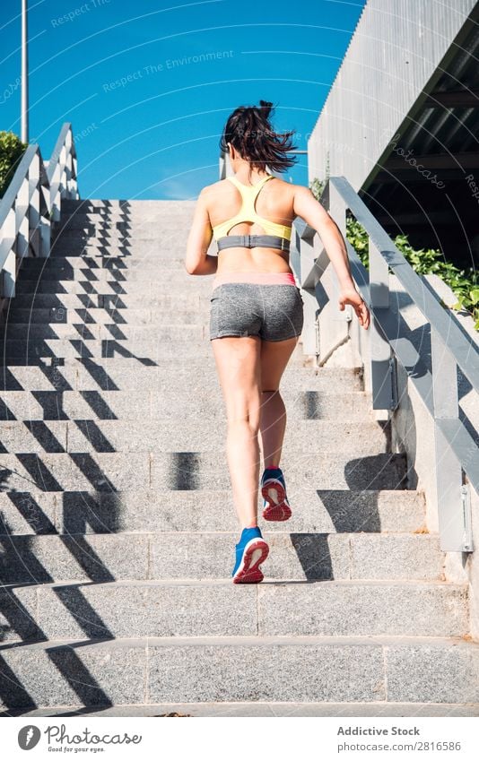 Athletic woman running up stairs during cardio - interval training Woman Fitness Running workout Speed Exterior shot Thin Heavy Determination Adults Human being