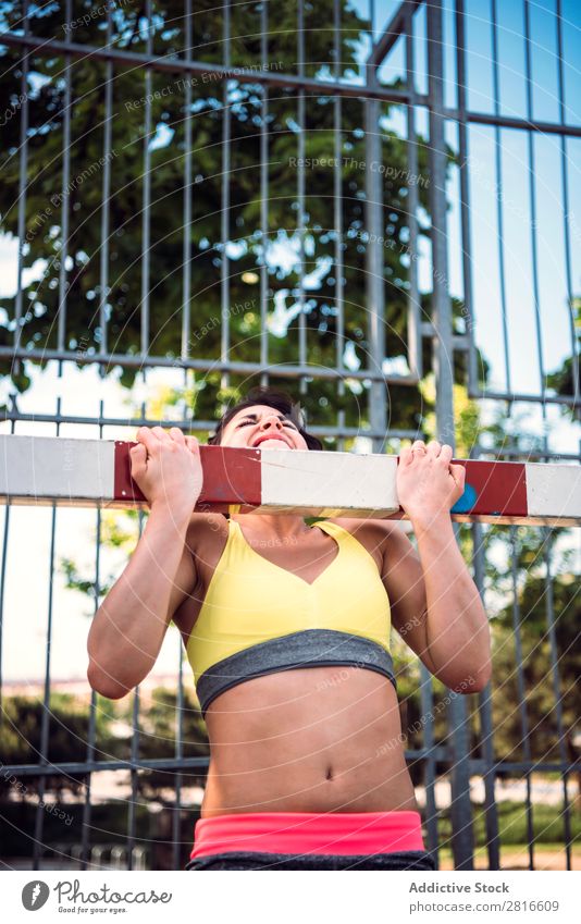 Young Woman working out outdoors and having fun Exterior shot Athletic Fitness Gymnasium Summer workout Park pushup Thin Determination Adults Strong Human being