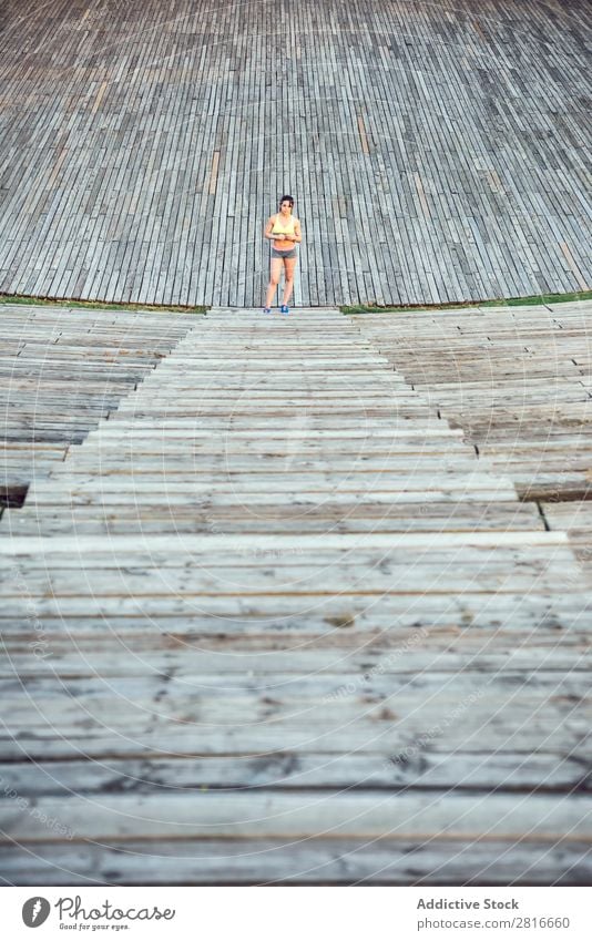Runner athlete running at wooden stairs. woman fitness jogging workout wellness concept. Woman Jogging Success Exterior shot Hiking Movement Adventure Action