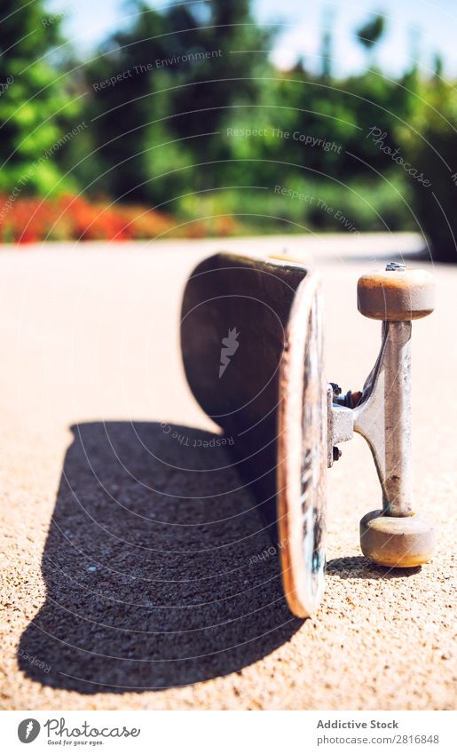 Old used skateboard over the ground Skateboard Skateboarding Wheels Retro Isolated Dirty Leisure and hobbies Joy Action Park Vantage point Horizontal Shot