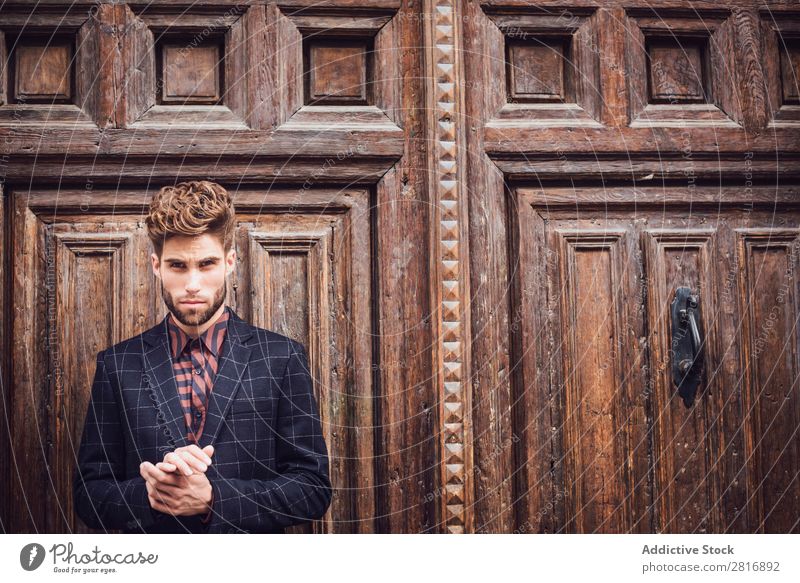 Handsome elegant young fashion man in trendy costume suit, old door wooden background Suit Man Gentleman Fashion fashionable Clothing Style Model Shirt