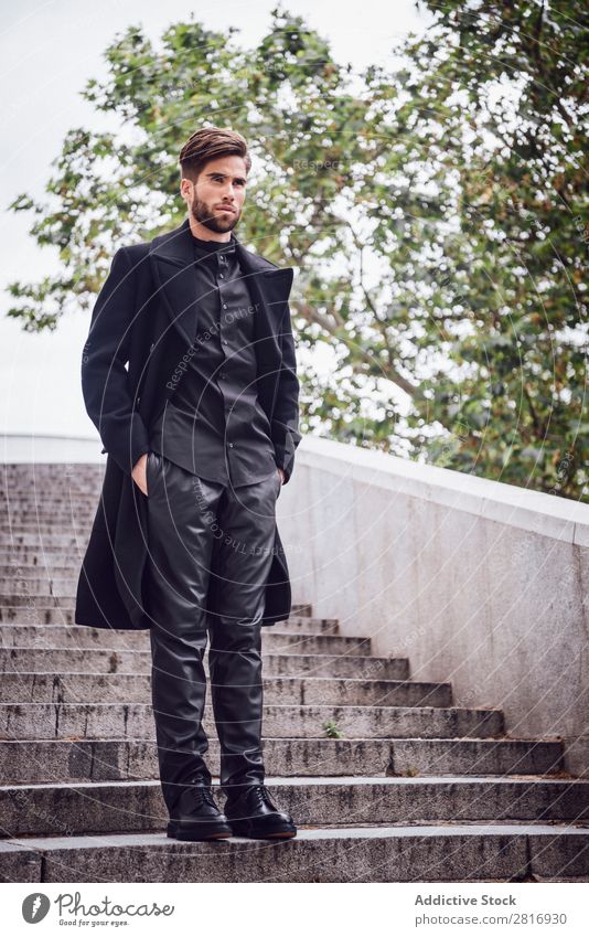 Young handsome trendy man with coat posing on stairs Adults Attractive Beard bearded Boy (child) Easygoing Caucasian Cool (slang) Cute Deep Expression