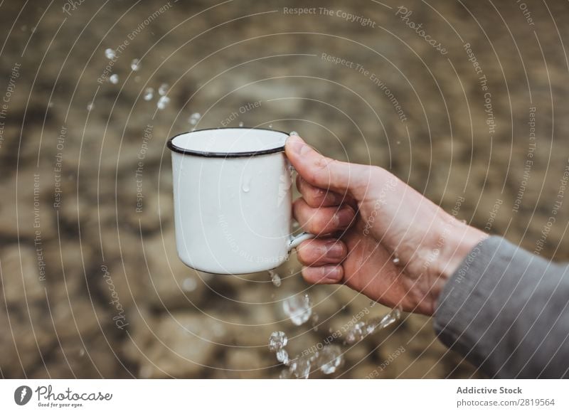 Milk splashing against a nude woman holding a cup of coffee Stock Photo