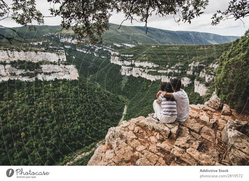 Couple sitting on cliff Cliff Landscape Nature Vacation & Travel Rock Adventure Man Woman Freedom Together Relationship Youth (Young adults) Love Embrace