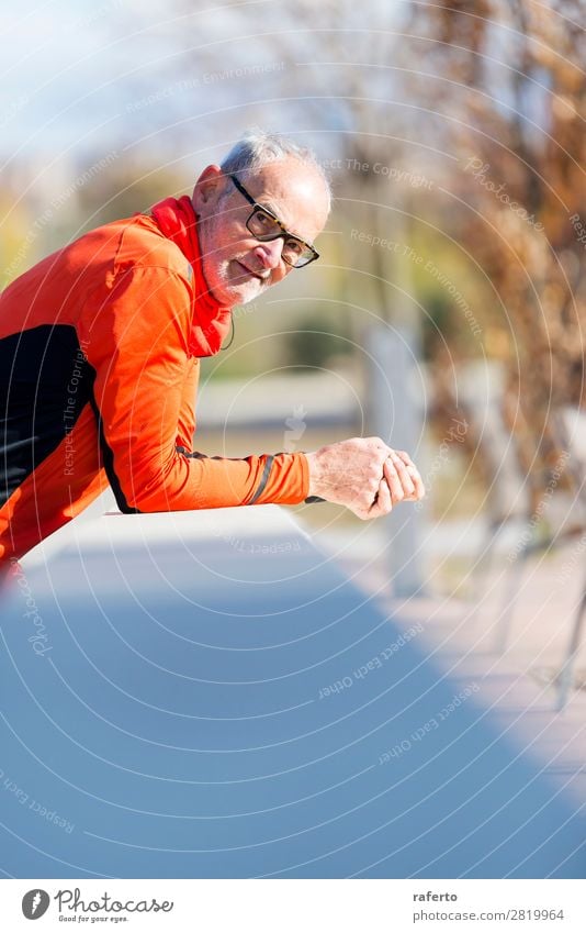 Senior runner man with sportswear leaning on a wooden fence Lifestyle Relaxation Sports Jogging Telephone Human being Masculine Man Adults Male senior 1