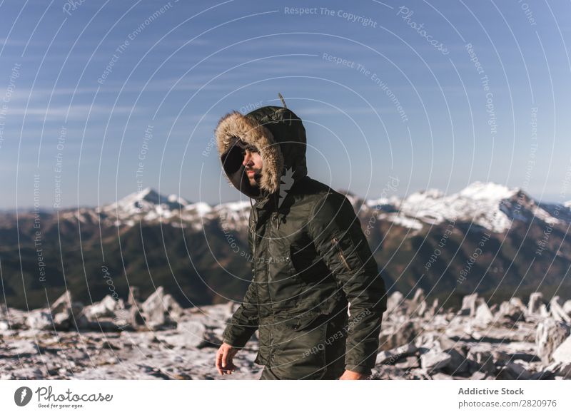 Man in outerwear on snowy mountains Mountain Snow hiker Action motivation Tourist Sunlight Stand Portrait photograph Tourism Weather Cold Extreme