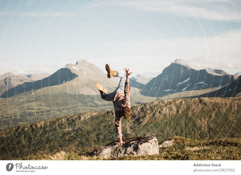 Man standing on hand on landscape Handstand Nature Mountain Landscape Extreme Balance Panorama (Format) Sports Healthy Natural traveler Valley Traveling