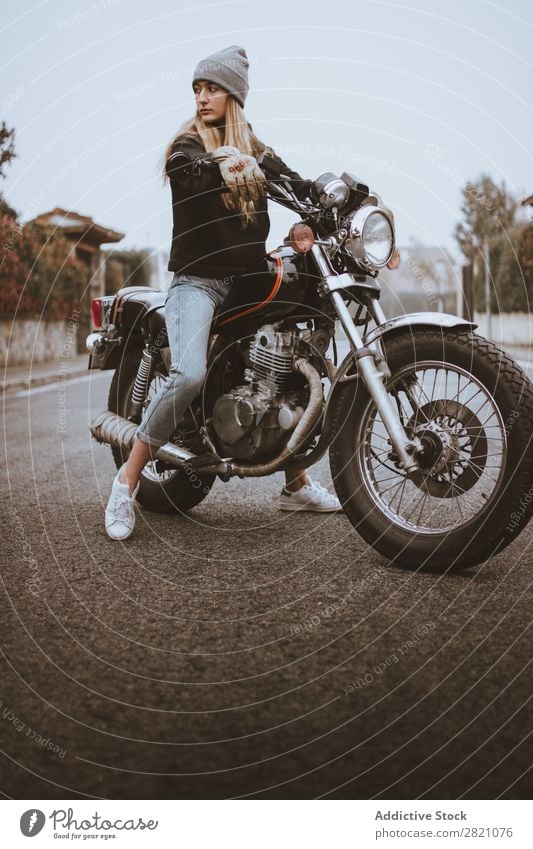 Young rebel girl posing on motorcycle Woman Motorcycle Earnest Leather Self-confident Transport Rider Rebel Uniqueness Lifestyle Vacation & Travel Nature