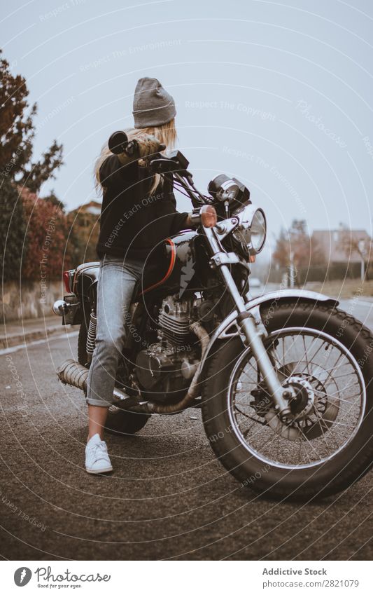Young girl posing on motorcycle Woman Motorcycle Earnest Leather Self-confident Transport Rider Rebel Uniqueness Lifestyle Vacation & Travel Nature