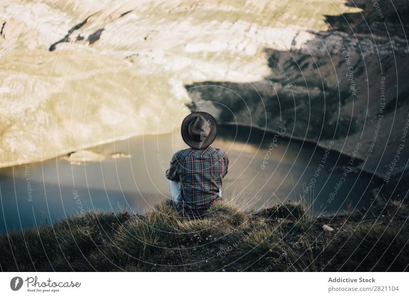 Anonymous man posing on nature Man Landscape Cliff Wanderlust Mountain Vacation & Travel Dream Loneliness Remote Edge scenery Lake Freedom Rock Adventure Nature