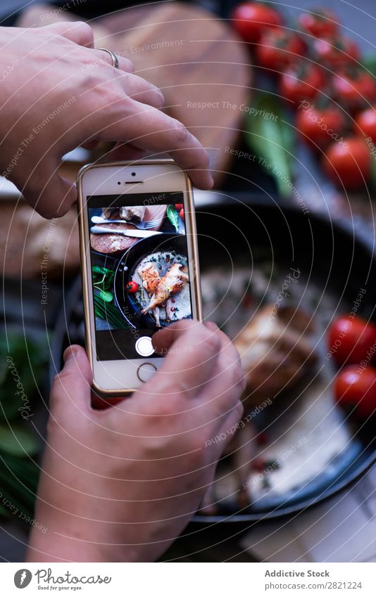 Hands taking shot of appetizing dish Poultry Tasty Dish Pan Frying Shot Take Display PDA Screen Tomato served Dinner Roasted Meal Meat Cooking Gourmet Food