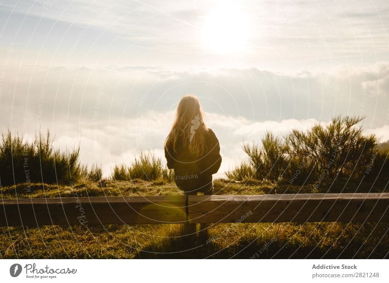 Woman sitting on wooden fence Nature enjoying Freedom Lifestyle Human being Leisure and hobbies Sunlight Sunbeam Day Sky Clouds Grass Recklessness Relaxation