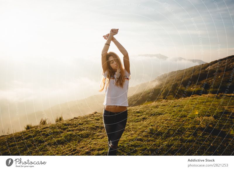 Young woman posing on a hill Woman Nature enjoying Freedom Lifestyle Human being Leisure and hobbies Sunlight Sunbeam Day Beautiful Lovely Charming Cute Grass