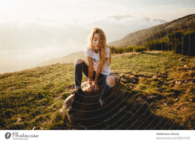 Young woman sitting on stone Woman Nature Stone Freedom Lifestyle Human being Leisure and hobbies Sunlight Sunbeam Day Beautiful Lovely Charming Cute Grass