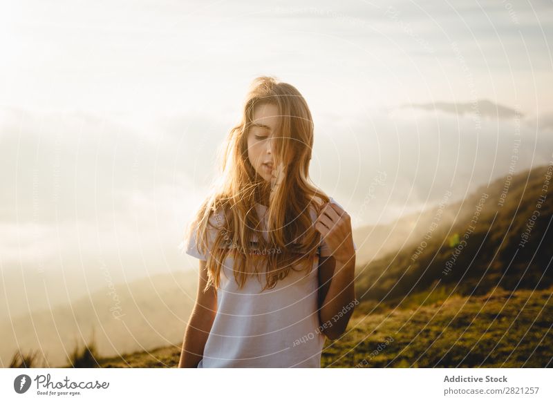 Young woman sitting on stone Woman Nature Stone Freedom Lifestyle Human being Leisure and hobbies Sunlight Sunbeam Day Beautiful Lovely Charming Cute Grass