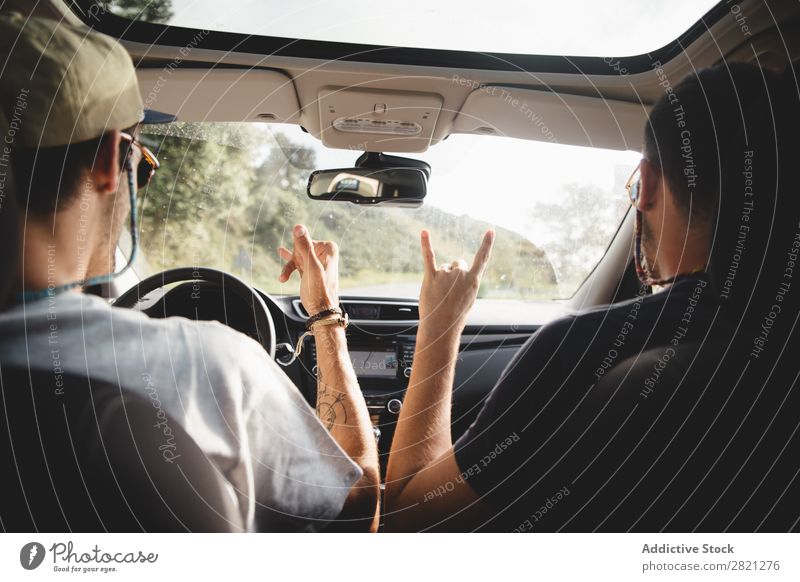 Men gesturing in a car Driving Car Man Friendship Gesture Welcome Trip Happy Summer Street Vacation & Travel Lifestyle Human being Couple Vehicle Joy Smiling