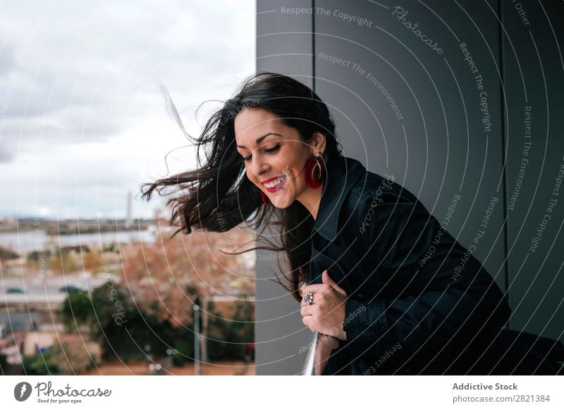 Cheerful woman standing at handrail Woman pretty Youth (Young adults) Beautiful Smiling Stand Balcony Building Modern Contemporary Brunette Attractive