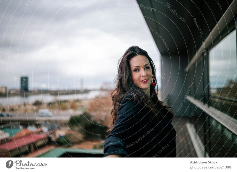 Cheerful woman standing at handrail Woman pretty Youth (Young adults) Beautiful Smiling Stand Balcony Building Modern Contemporary Brunette Attractive