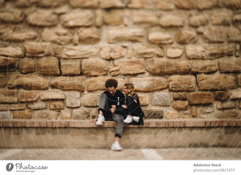 Smiling couple on stone background Couple Portrait photograph Copy Space Background picture Wall (building) Stone Sit Bench Exterior shot Day Hipster Love
