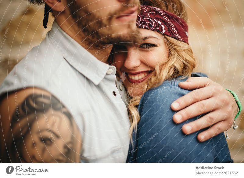 pretty girlfriend with band on head in boyfriends embrace Couple Smiling Close-up Looking into the camera Embrace Hand focus Tattoo Portrait photograph Face