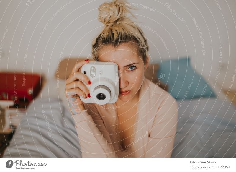 Pretty woman with instant camera Woman pretty Attractive Camera Aim focusing Photographer Hot Alluring Sit Bed Bedroom Arm Happy Beautiful Youth (Young adults)