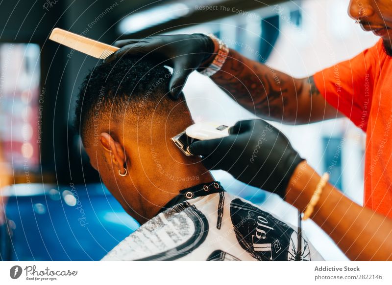 Barber using grooming machine Barber shop Customer hair dress Hair salon Hairdresser Black Man Youth (Young adults) Client Hair Stylist Hair and hairstyles