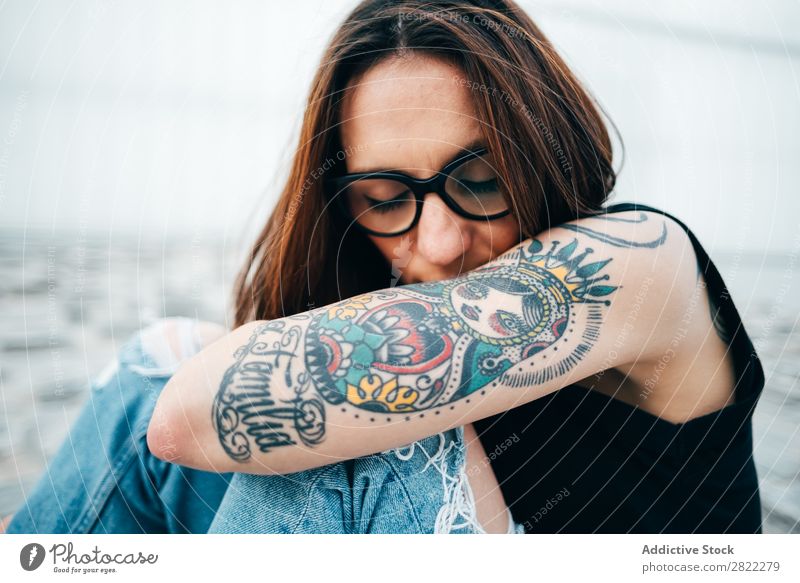 Woman with tattoos sitting on pavement Style Tattoo Sit Old Pavement Person wearing glasses Relief Street Beautiful Youth (Young adults) Fashion Hipster pretty