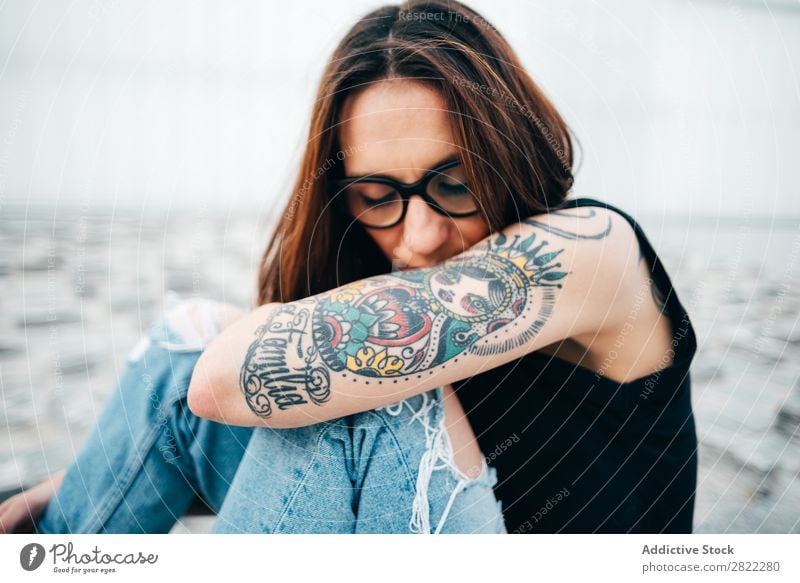 Woman with tattoos sitting on pavement Style Tattoo Sit Old Pavement Person wearing glasses Relief Street Beautiful Youth (Young adults) Fashion Hipster pretty
