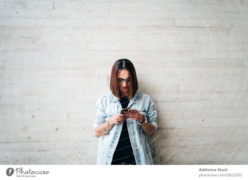 Woman with smartphone at concrete wall Style PDA Lean Concrete Wall (building) using browsing Street Beautiful Youth (Young adults) Fashion Hipster pretty