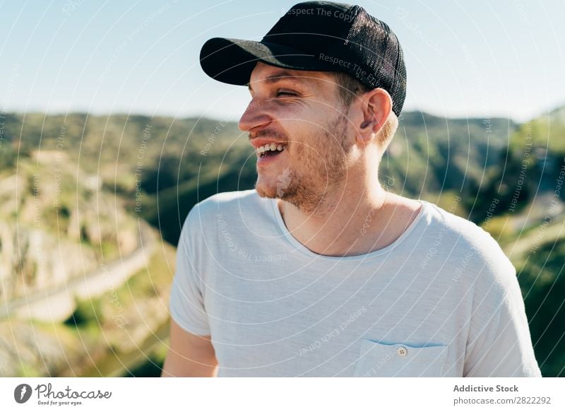 Cheerful man in mountains Man Mountain Cap Happy Youth (Young adults) Adventure Nature Healthy Vacation & Travel Human being Lifestyle Portrait photograph