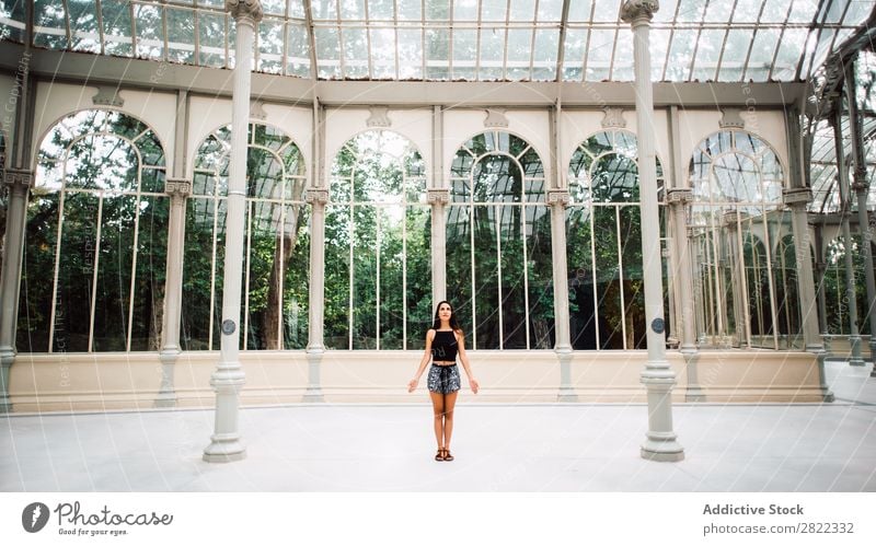 Pretty woman in glass house Woman pretty Youth (Young adults) Beautiful Brunette Stand Glass House (Residential Structure) Garden Park Attractive Human being