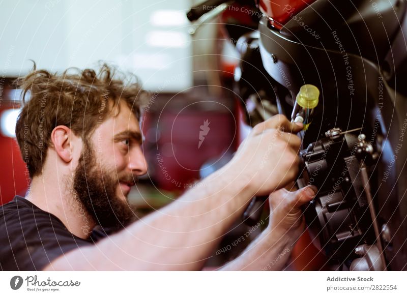 Man working on bike Maintenance Detail Part Employees &amp; Colleagues Motorcycle Workshop Human being Engines Transport Vehicle Garage custom repair shop