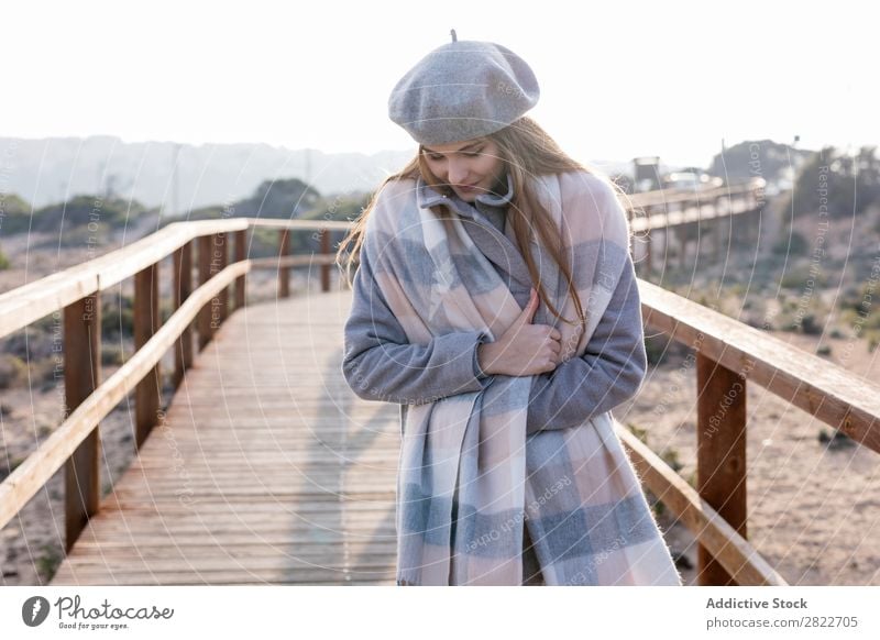 Cheerful woman standing at boardwalk Woman pretty Youth (Young adults) Beautiful Attractive Smiling Corridor Wood Nature Style Beret Human being Coat