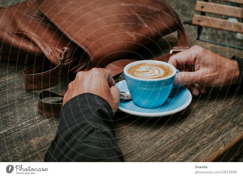 Man holding blue coffee cup on wooden table Beverage Hot drink Coffee Latte macchiato Espresso Lifestyle Elegant Style Human being Hand 1 45 - 60 years Adults